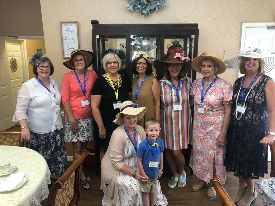 Members of the Women’s Ministry group of St. Martin Parish in St. Martins, accompanied by their young chaperone, prepare to share high tea with residents of Westbrook Terrace in Jefferson City June 12.